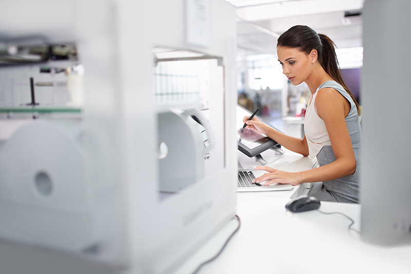 young female creating something with a 3d printer