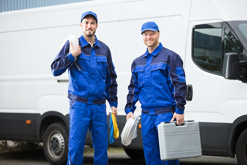 two plumbers who just arrived at a job site