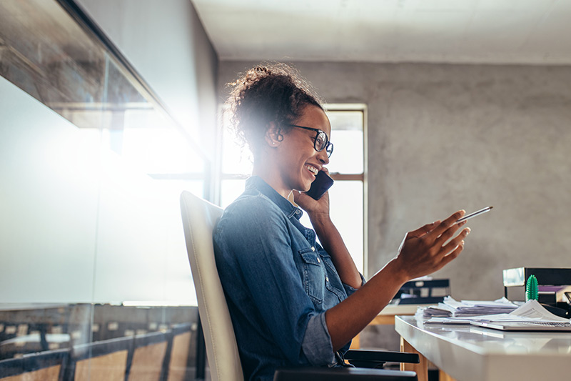 female entrepreneur on a phone call at her desk