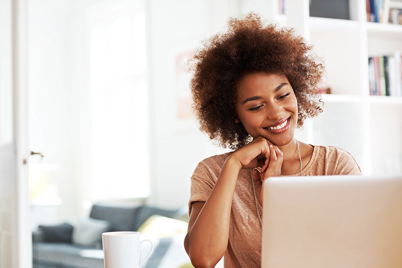 happy female business owner using her computer