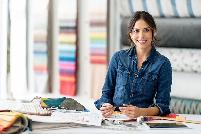 female upholstery business owner looking at fabric swatches