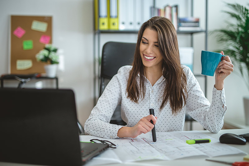 female entrepreneur having coffee at her desk