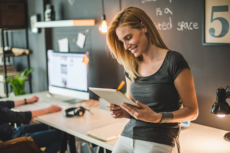 blonde female entrepreneur using a tablet