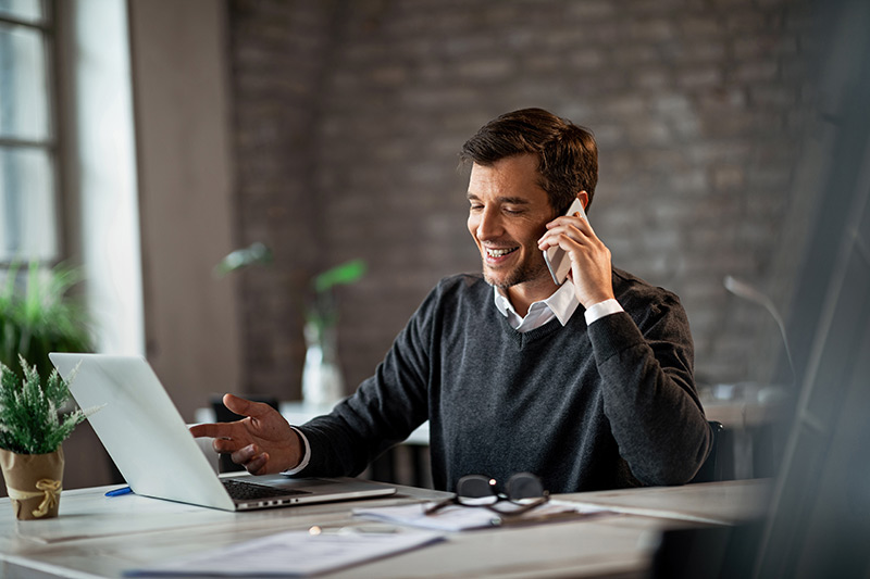 young male business owner on a phone call