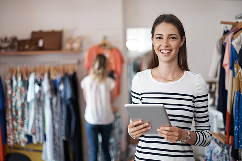young female retail shop owner with a tablet