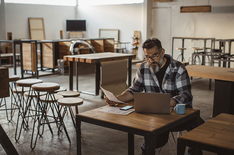 male restaurant owner doing paperwork after hours