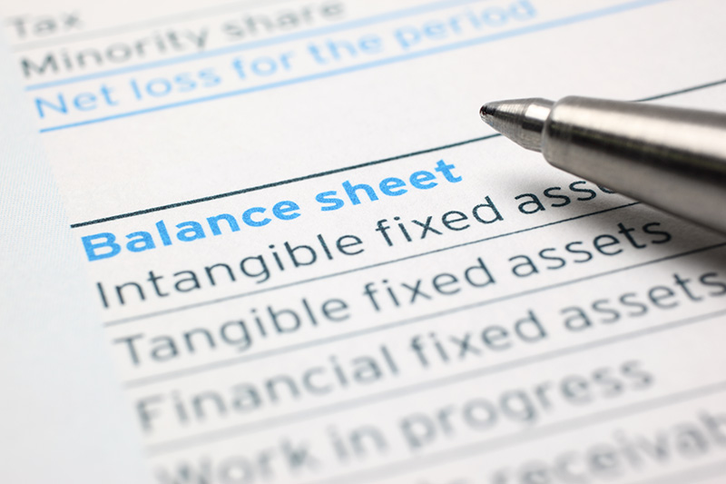 close up of a pen on a business balance sheet