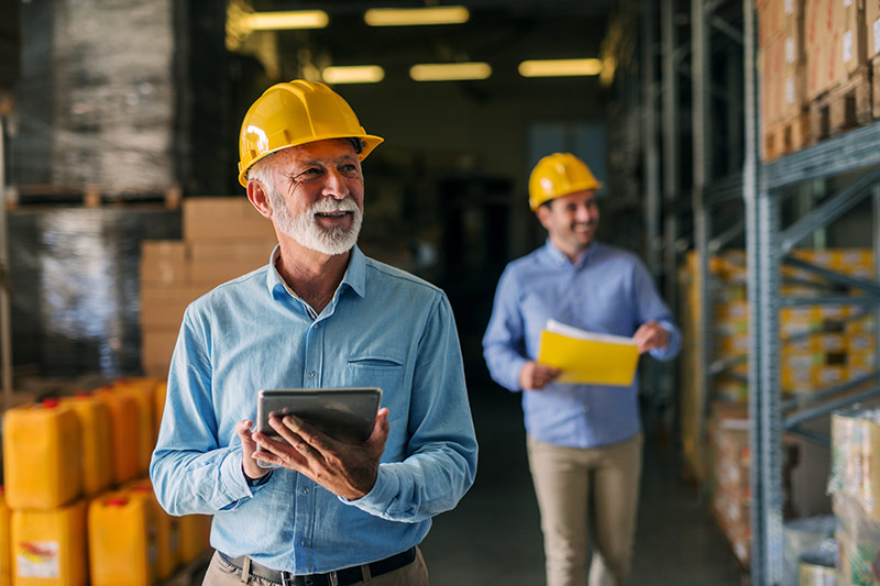 two warehouse workers taking inventory