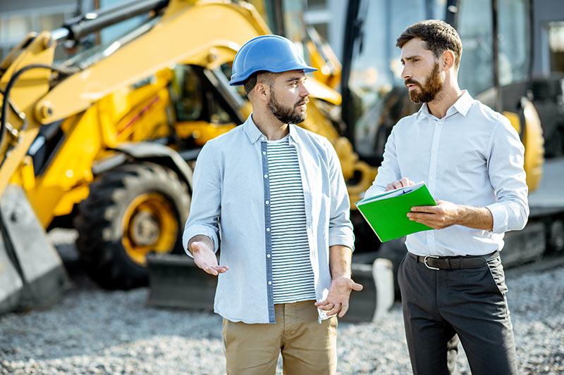 two workers talking at a construction site