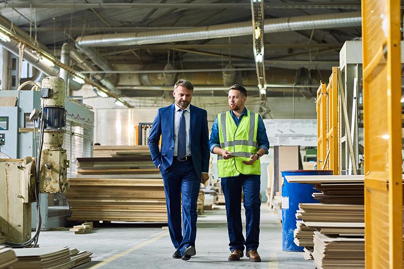 two businessmen walking in a warehouse