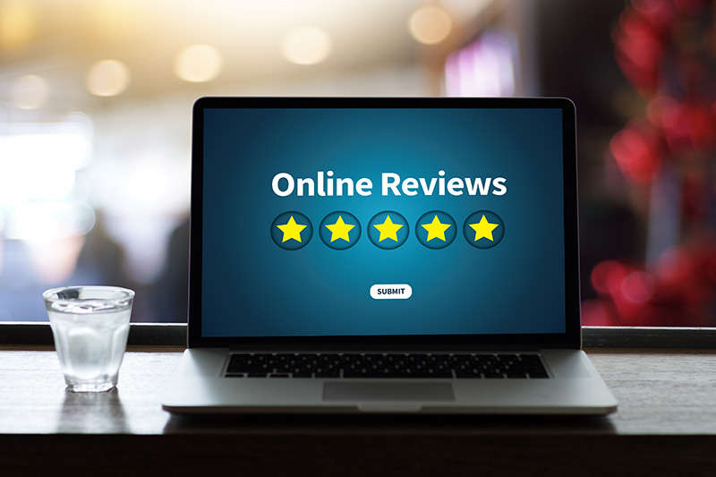 laptop showing online reviews with five stars