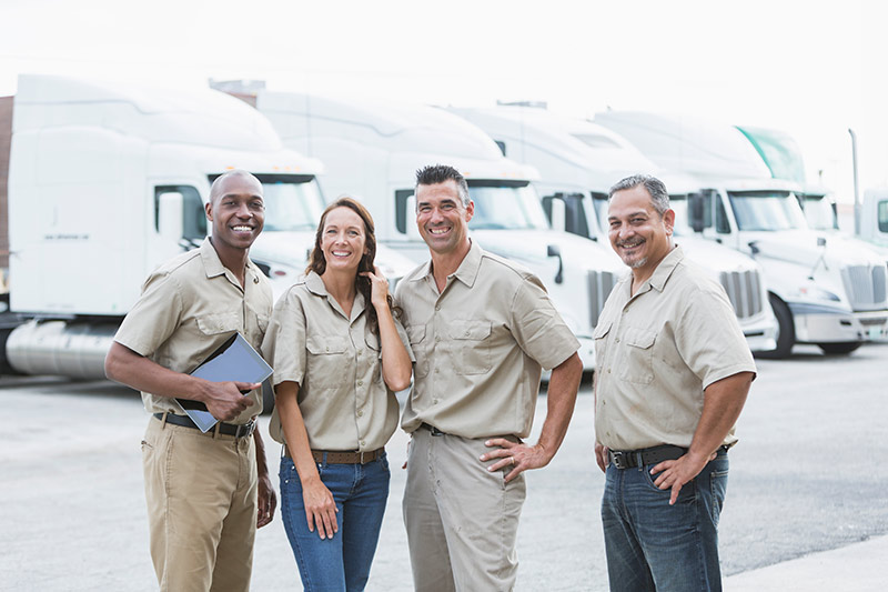 four truck owners standing in a truck lot