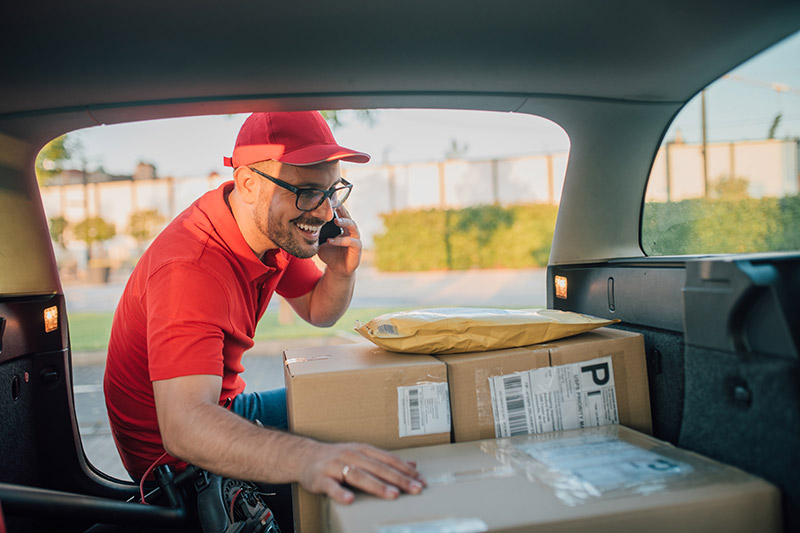 young male business owner delivering packages to his customers