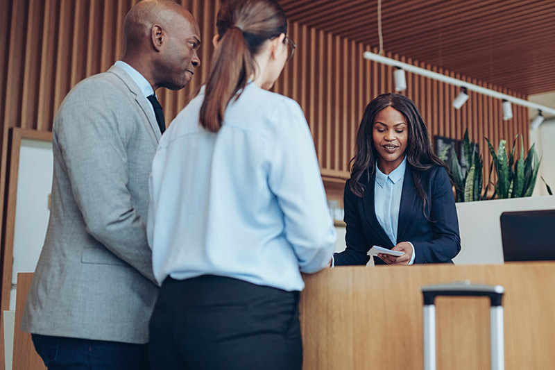 guests checking into a hotel franchise